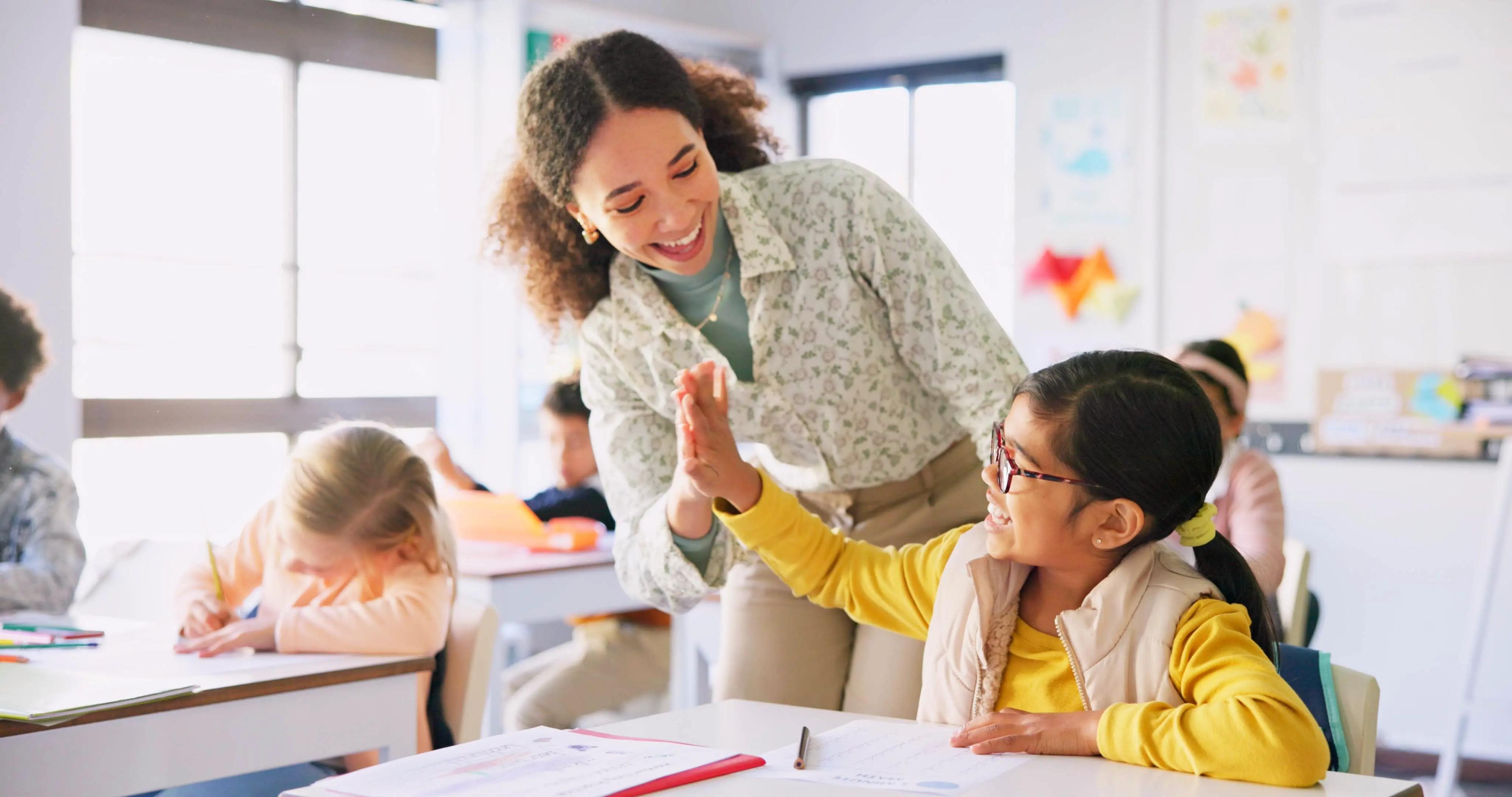 Teacher helping children in classroom